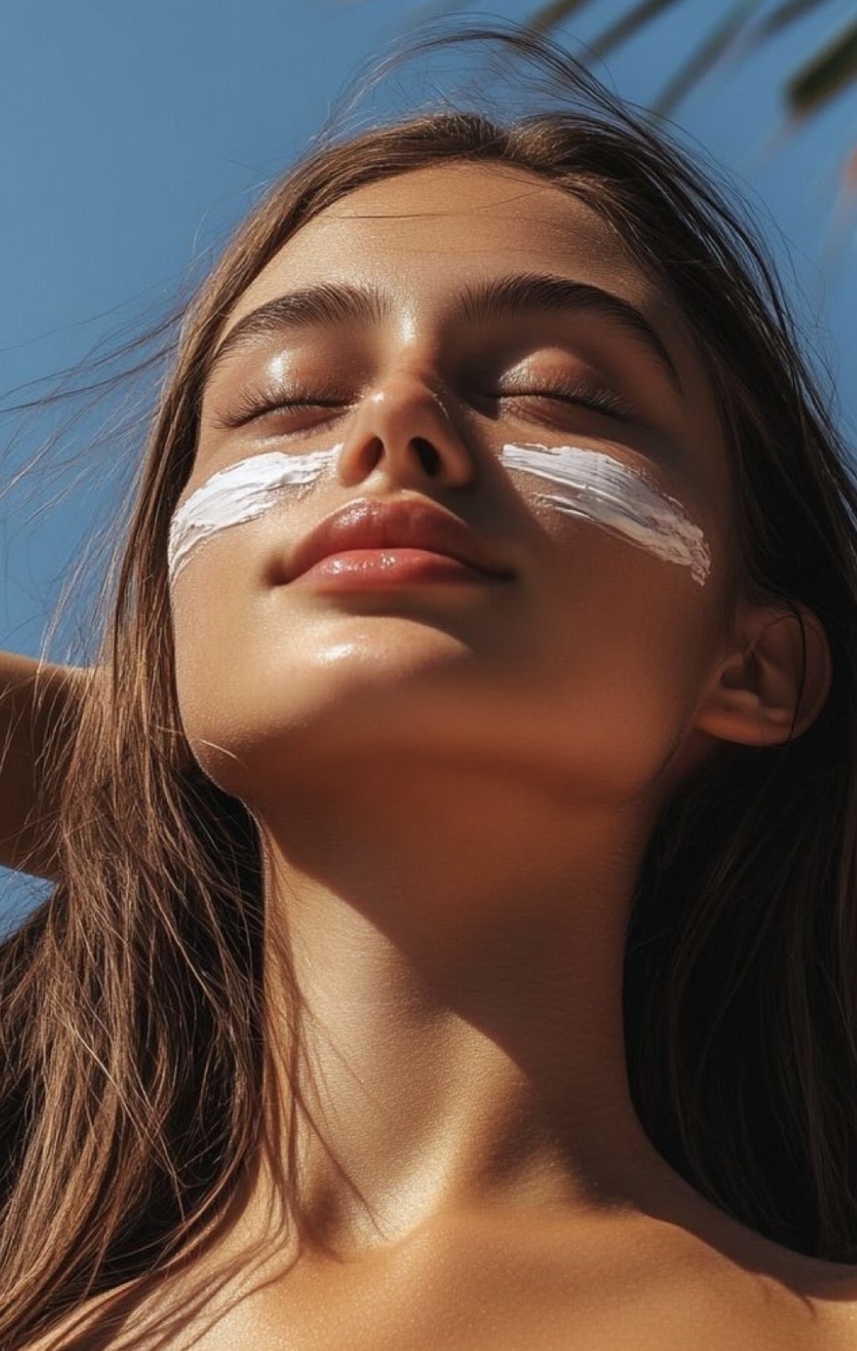 girl on beach with sunblock on cheeks