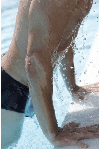 male swimmer getting out of the pool