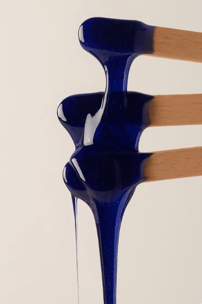 blue hard wax on wooden spatula